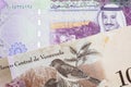 A bolivar note from Venezuela with a five riyal note from Saudi Arabia