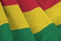 Bolivia flag with big folds waving close up under the studio light indoors. The official symbols and colors in banner