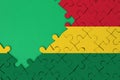 Bolivia flag is depicted on a completed jigsaw puzzle with free green copy space on the left side