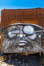 Bolivia Uyuni face of man with beard drawn on old locomotive