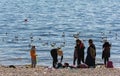 A bolivian family have a picnic next to the coast of Titicaca Lake in Copacabana, Bolivia