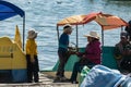 A bolivian family in a wooden pier during sunset in Copacabana, Bolivia