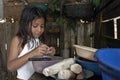 Bolivian girl cooking at home in kitchen Royalty Free Stock Photo