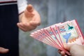 Bolivian money, A large file of banknotes passed from hand to hand