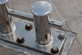 A bollard made of corrosion-resistant steel is installed on the pier of the seaport. Royalty Free Stock Photo