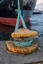 Bollard with mooring ropes at the pier. The ship is moored. The bow of the ship Royalty Free Stock Photo