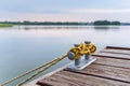 Knotted and tied up rope on wooden pier. Royalty Free Stock Photo