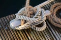 Bollard robust of steel on boat in harbor with rope that connects to the jetty. A safe home place for sailing. Royalty Free Stock Photo