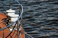 Bollard on ship deck with metal mooring lines.