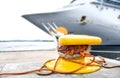 Bollard on which a large ship is moored with ropes Royalty Free Stock Photo