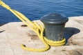 Bollard with yellow rope Royalty Free Stock Photo