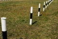 bollards on a background of grass. light steel bollards on ground Royalty Free Stock Photo
