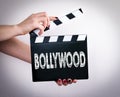 Bollywood. Female hands holding movie clapper Royalty Free Stock Photo
