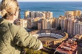 Bolnde female touris enjoying amazing panoramic aerial view of bull ring in Malaga, Spain Royalty Free Stock Photo