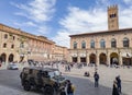 Palazzo del Podesta and Piazza Maggiore city square in Bologna with tourists and Iveco army vehicle