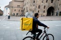Bologna, Italy - 13 april 2019: young glovo rider making delivery on his bike working in the so called gig economy in an italian Royalty Free Stock Photo