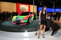 BOLOGNA, ITALY - DECEMBER 2, 2010: beautiful fashion model poses with Citroen prototype spot car at the Bologna Motor Show.