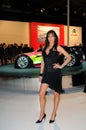 BOLOGNA, ITALY - DECEMBER 2, 2010: beautiful fashion model poses with Citroen prototype spot car at the Bologna Motor Show.