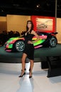 BOLOGNA, ITALY - DECEMBER 2, 2010: beautiful fashion model poses with Citroen prototype spot car at the Bologna Motor Show.