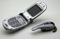 Motorola Cell Phone V600 GSM Sim Free with Bluetooth Headset. Vintage Technology Royalty Free Stock Photo