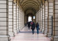 BOLOGNA, ITALY - 17 FEBRUARY, 2016: People Walking through a Portico, sheltered walkway, in Bologna with its almost 40 kilometres