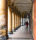 BOLOGNA, ITALY - 17 FEBRUARY, 2016: People Walking through a Portico, sheltered walkway, in Bologna with its almost 40 kilometres