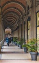 BOLOGNA, ITALY - 17 FEBRUARY, 2016: People Walking through a Portico, sheltered walkway, in Bologna with its almost 40 kilometres