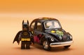 Lego Batman ready for driving a vintage Volkswagen Beetle painted in Hippie lifestyle