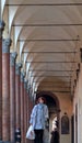 People Walking through a Portico, sheltered walkway in Bologna Royalty Free Stock Photo