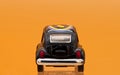 Collectible toy model car Volkswagen Beetle decorated in Hippie lifestyle. Rear view Royalty Free Stock Photo