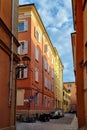 Bologna, Italy, May 19, 2024: Charming European Alleyway with Colorful Buildings and Cobbled Street under Blue Sky