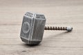 The hammer of Thor isolated on wooden background.