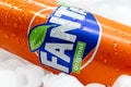 Can of Fanta soda on ice with water droplets. Royalty Free Stock Photo