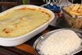 bolognese lasagna baked with cheese ham red sauce spices and meat with french fries and rice Royalty Free Stock Photo