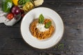 Bolognese pasta with cheese and herbs. A hot main course of spaghetti, minced meat, tomato paste, parmesan cheese and basil Royalty Free Stock Photo