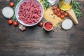 Bolognese pasta cooking concept, raw minced meat, tomato paste, cherry tomatoes, pasta, onion, garlic, herbs herbs, oil and ho Royalty Free Stock Photo