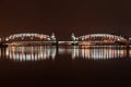 Bolsheokhtinsky bridge across the Neva River in St. Petersburg, evening illumination reflected in the water Royalty Free Stock Photo