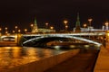 Bolshoy Kamenny Bridge with illumination over Moskva river at night. View from Sofiyskaya Embankment Royalty Free Stock Photo