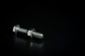 Bolt and nut isolated on a black background with space for text. Royalty Free Stock Photo
