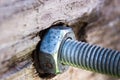 Bolt and nut twisted into a wooden board Royalty Free Stock Photo