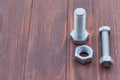 Bolt and nut on a wooden background. Close-up. Copy space Royalty Free Stock Photo