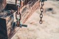 The bolt on the old wood swing and chain Royalty Free Stock Photo