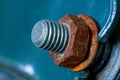 Bolt and rusty brown nut on a green metal wall Royalty Free Stock Photo