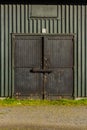 Bolted and shut door on a green storage shed