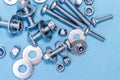 Bolts, nuts and washers of different sizes on a blue background Royalty Free Stock Photo