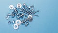 Bolts, nuts and washers of different sizes on a blue background Royalty Free Stock Photo