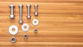 Bolts, nuts and washers of different sizes and wooden bamboo table surface. Copy space for text Royalty Free Stock Photo