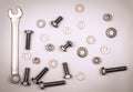 Bolts, nuts, washers and wrench on a gray background Royalty Free Stock Photo