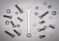 Bolts, nuts, washers and wrench on a gray background Royalty Free Stock Photo