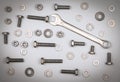 Bolts, nuts, washers and wrench on a gray background Royalty Free Stock Photo